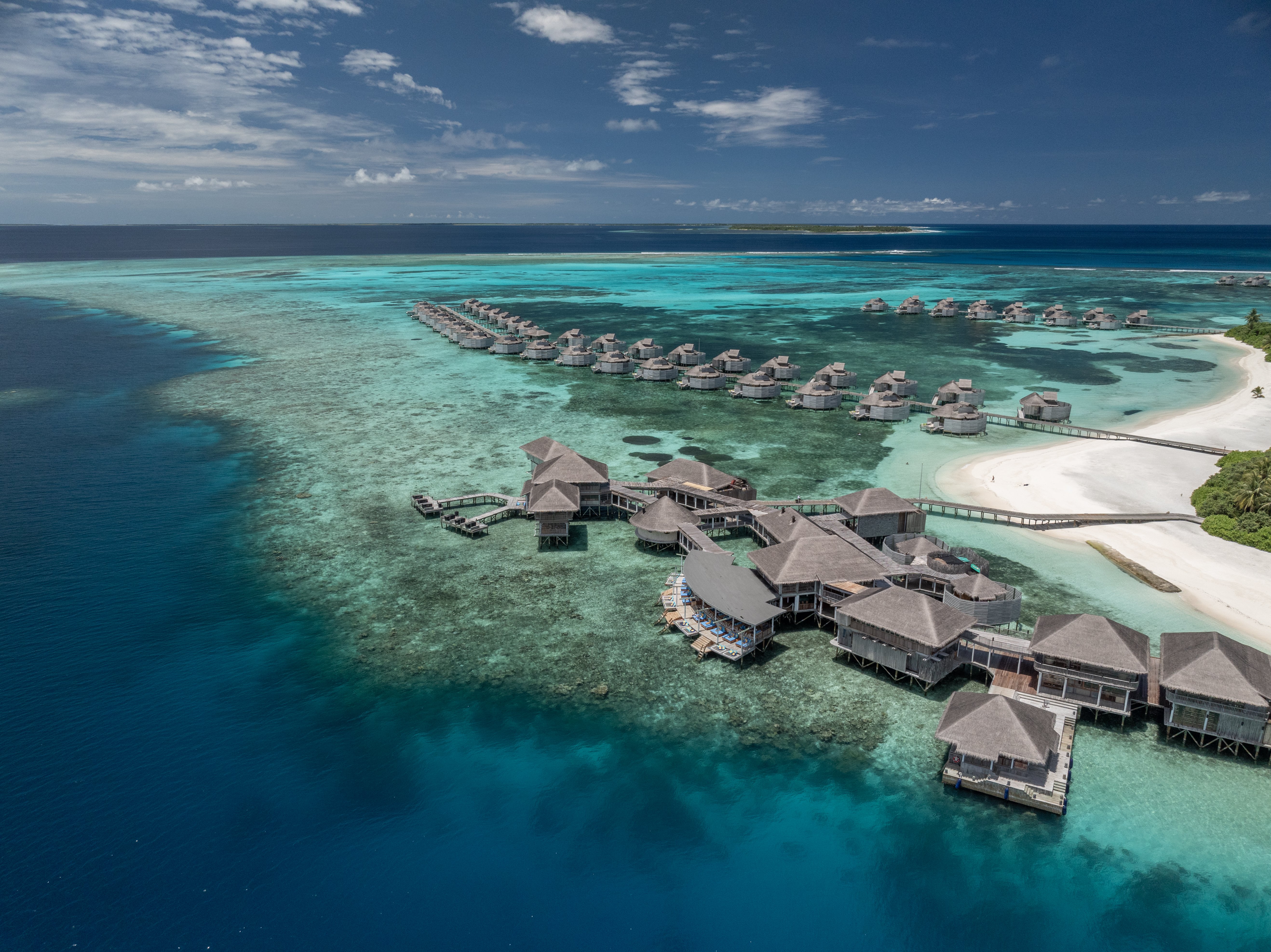 Six Senses Laamu beach villa interior with timber construction and natural materials reflecting the brand's sustainable luxury architectural philosophy