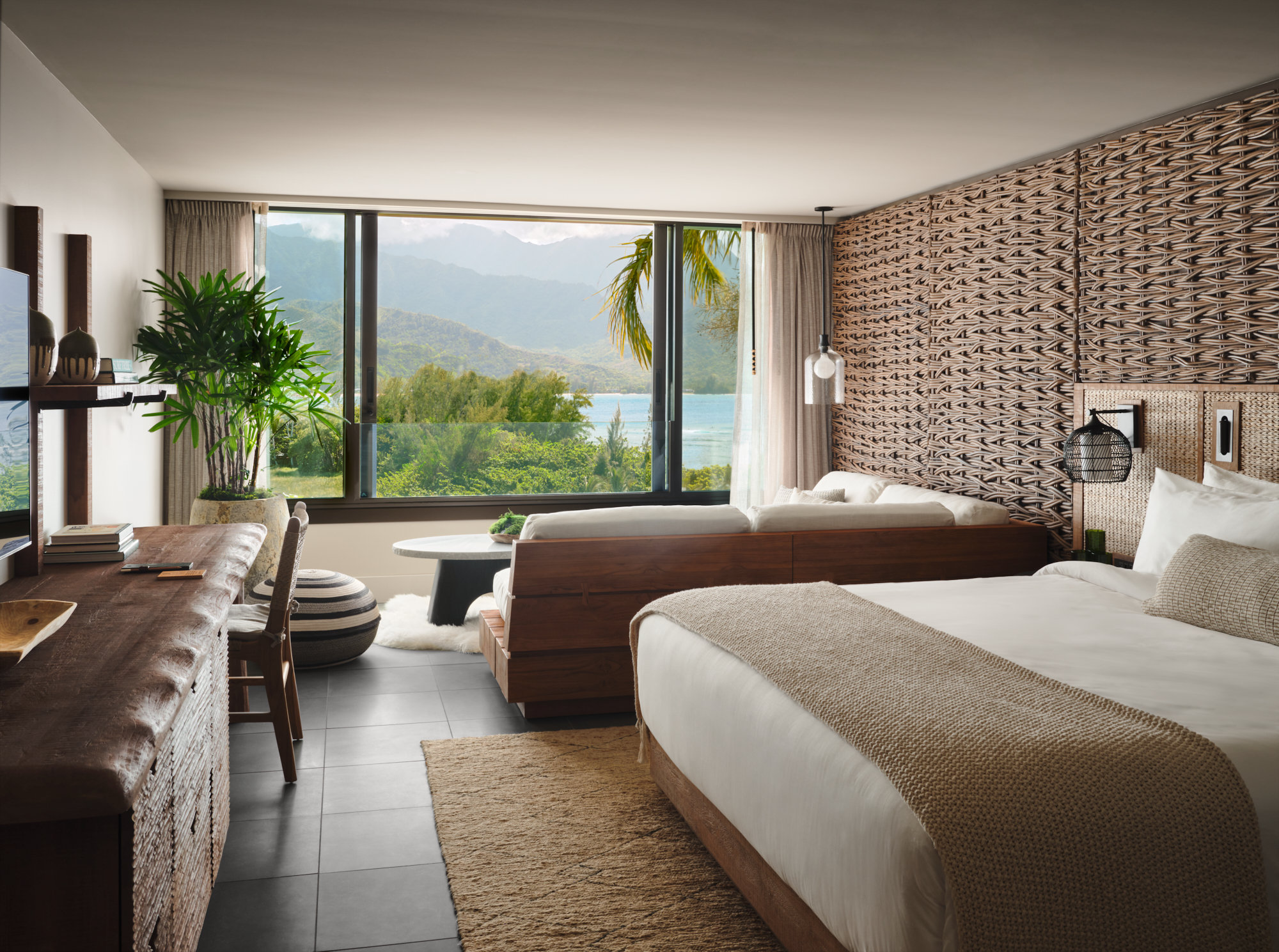 1 Hotel Hanalei Bay guest room interior showing the brand's signature reclaimed-wood and natural-materials design philosophy with Pacific Ocean views
