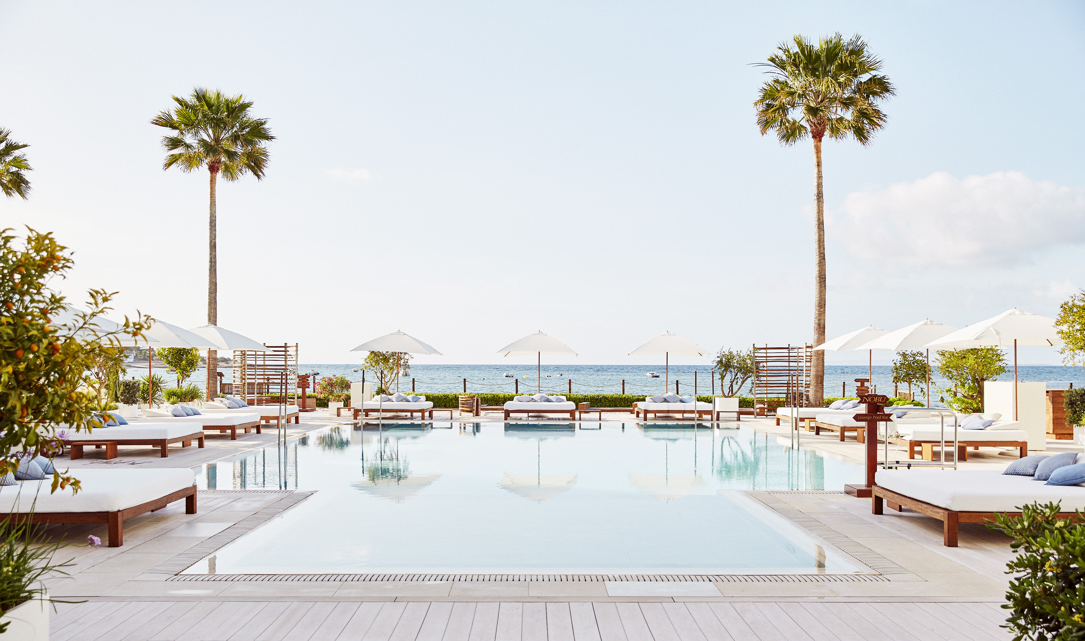 Nobu Hotel Ibiza Bay beachfront pool configuration with the substantial outdoor cabana programming and the dedicated Mediterranean view that defines the property's contemporary White Isle luxury identity