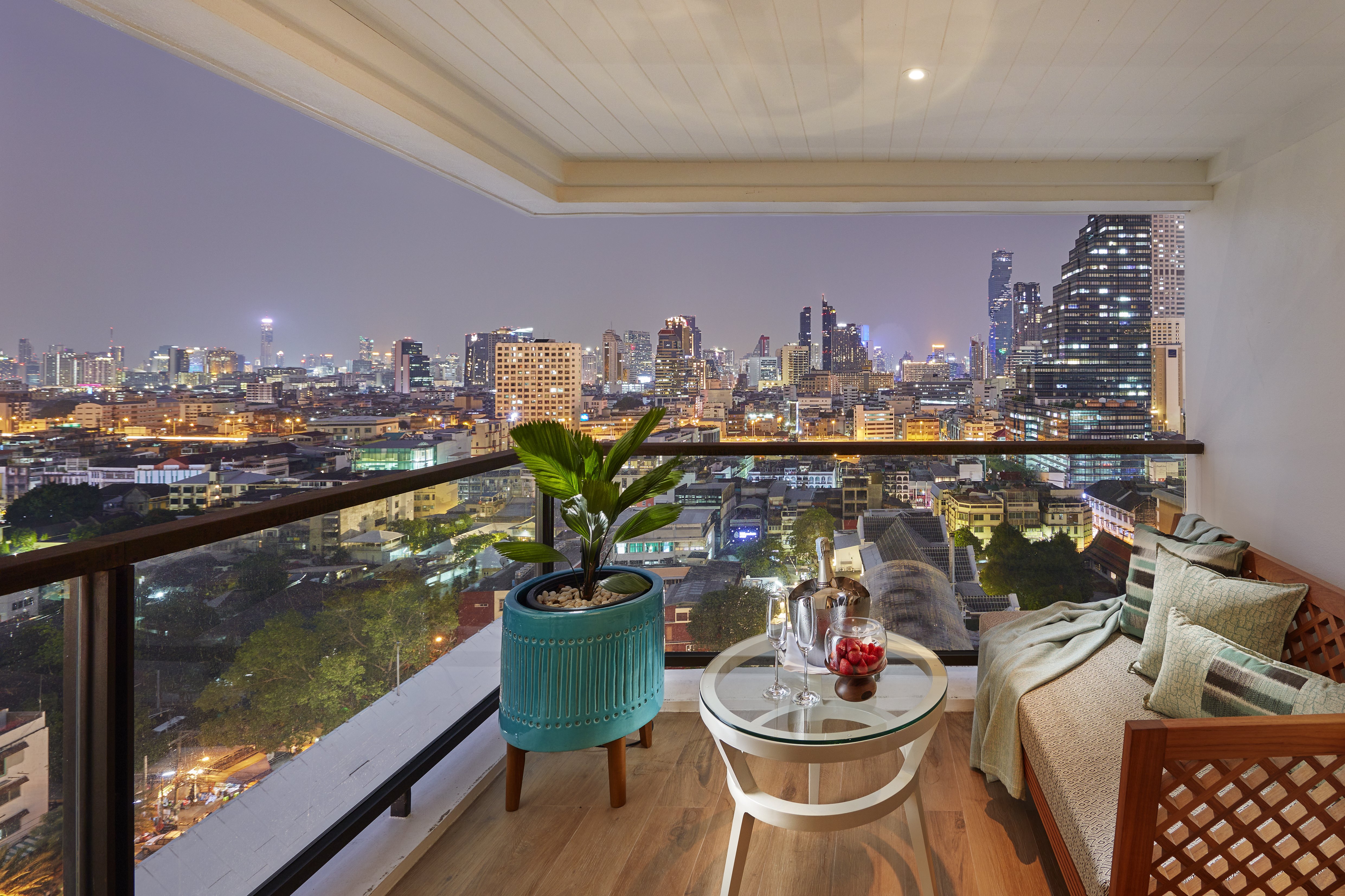 Mandarin Oriental Bangkok Oriental Spa treatment room with traditional Thai design elements and dark teak woodwork