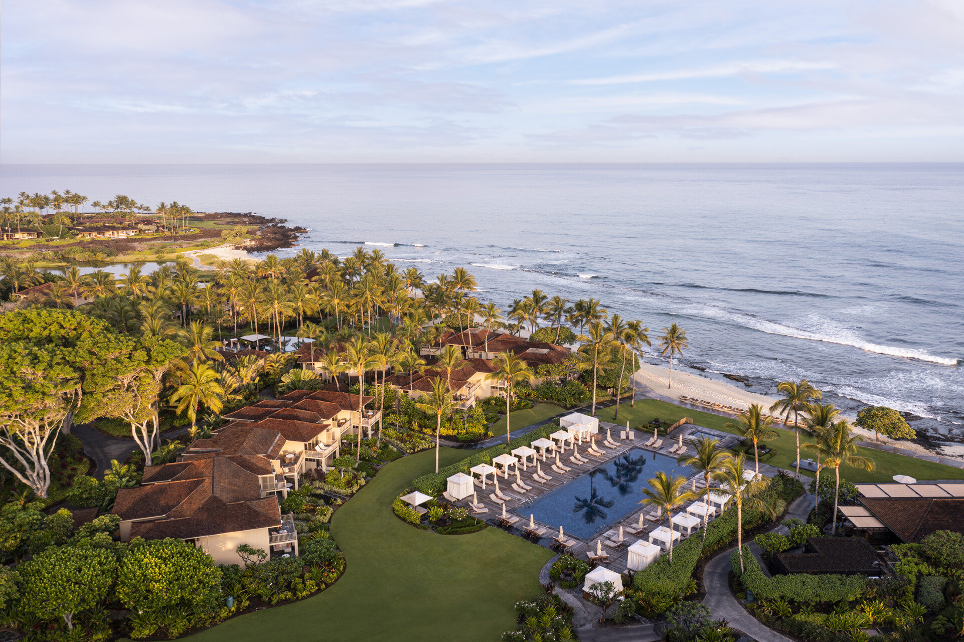 A Four Seasons Resort Hualalai guest accommodation with the substantial Pacific coastline orientation and the dedicated low-rise Hawaiian bungalow interior configuration evocative of the property's specific Big Island volcanic-and-Pacific luxury identity