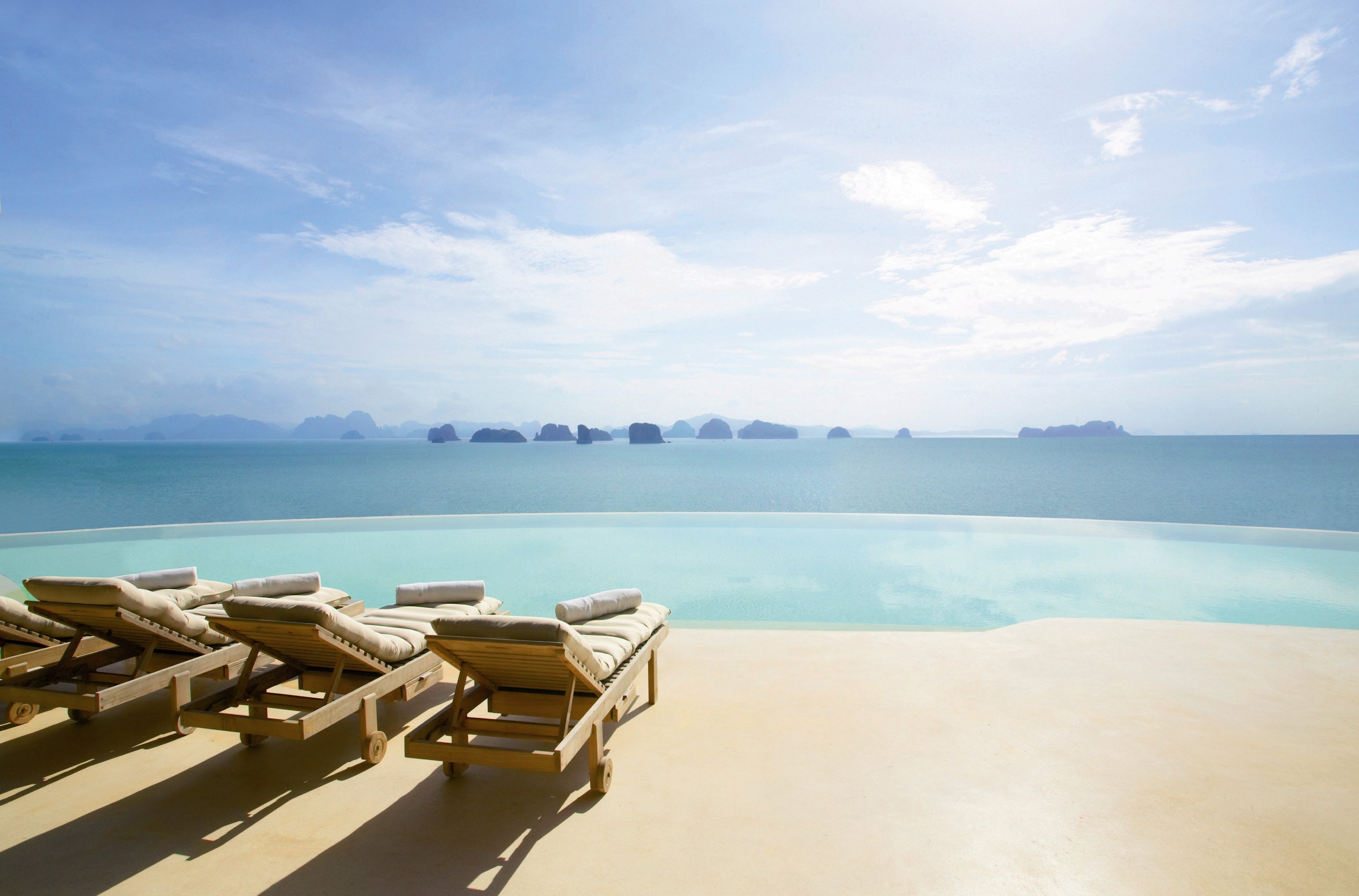 Six Senses Yao Noi villa interior with traditional Thai architectural detailing and the Andaman Sea view through the floor-to-ceiling sliding glass