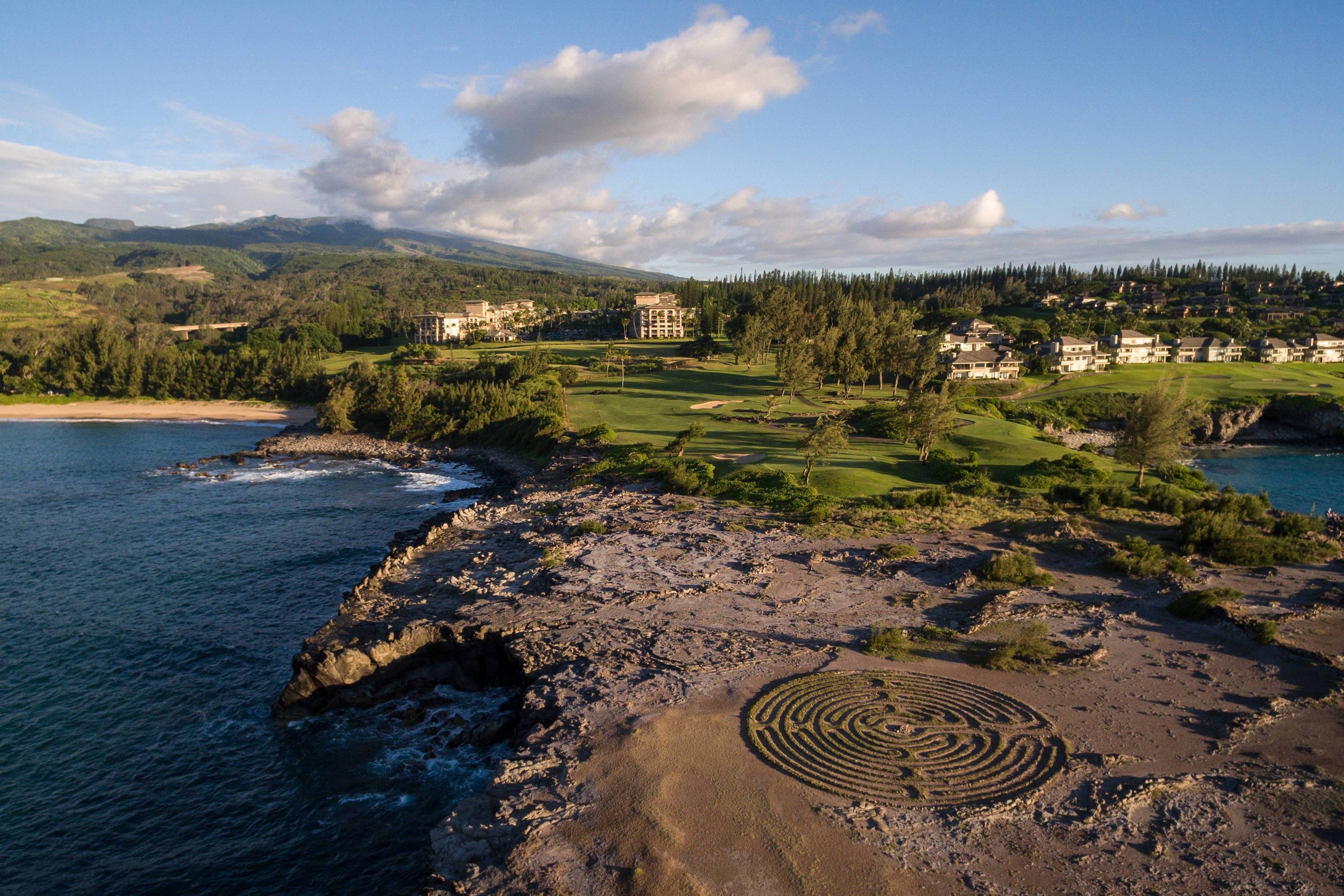 The Ritz-Carlton Maui Kapalua oceanfront beach with the Honolua Bay coastline and the Molokai island view across the channel