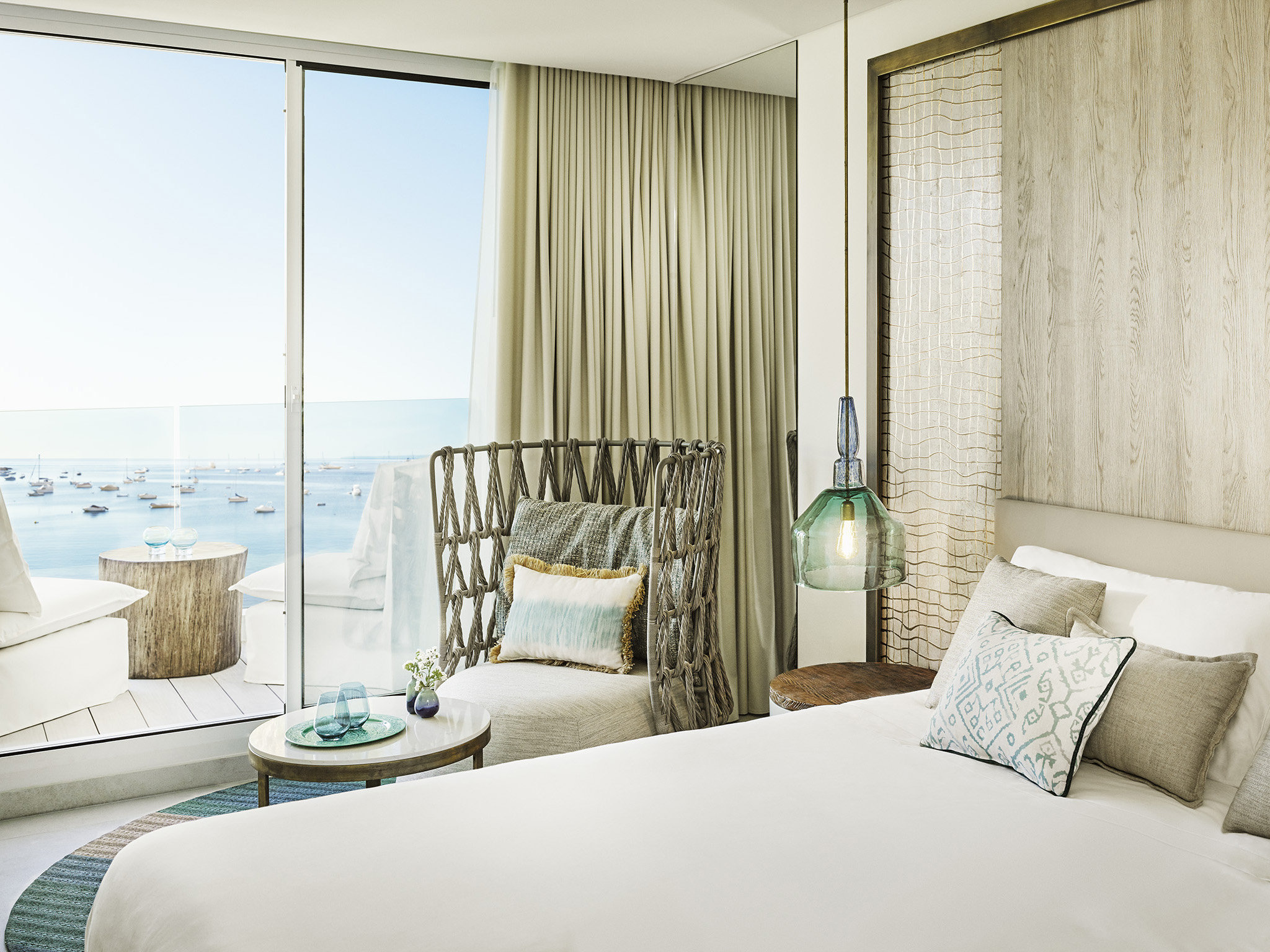 Nobu Hotel Ibiza Bay guest room with contemporary Japanese-Mediterranean architectural detailing and the unobstructed Talamanca Bay Mediterranean view through the floor-to-ceiling sliding glass