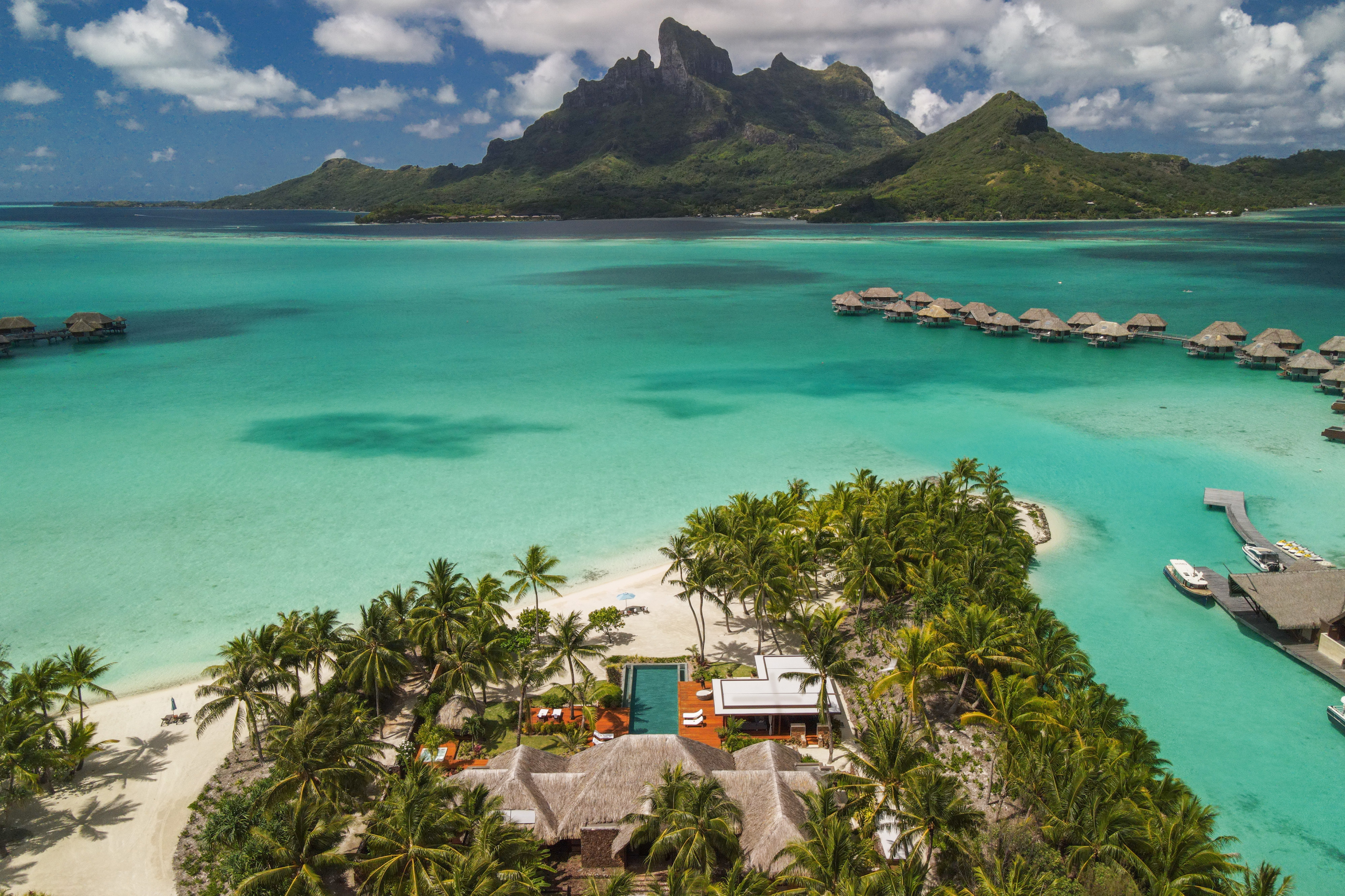 Mount Otemanu Overwater Bungalow Suite at Four Seasons Resort Bora Bora with private deck, freshwater pool, and direct lagoon access facing the iconic volcanic peak