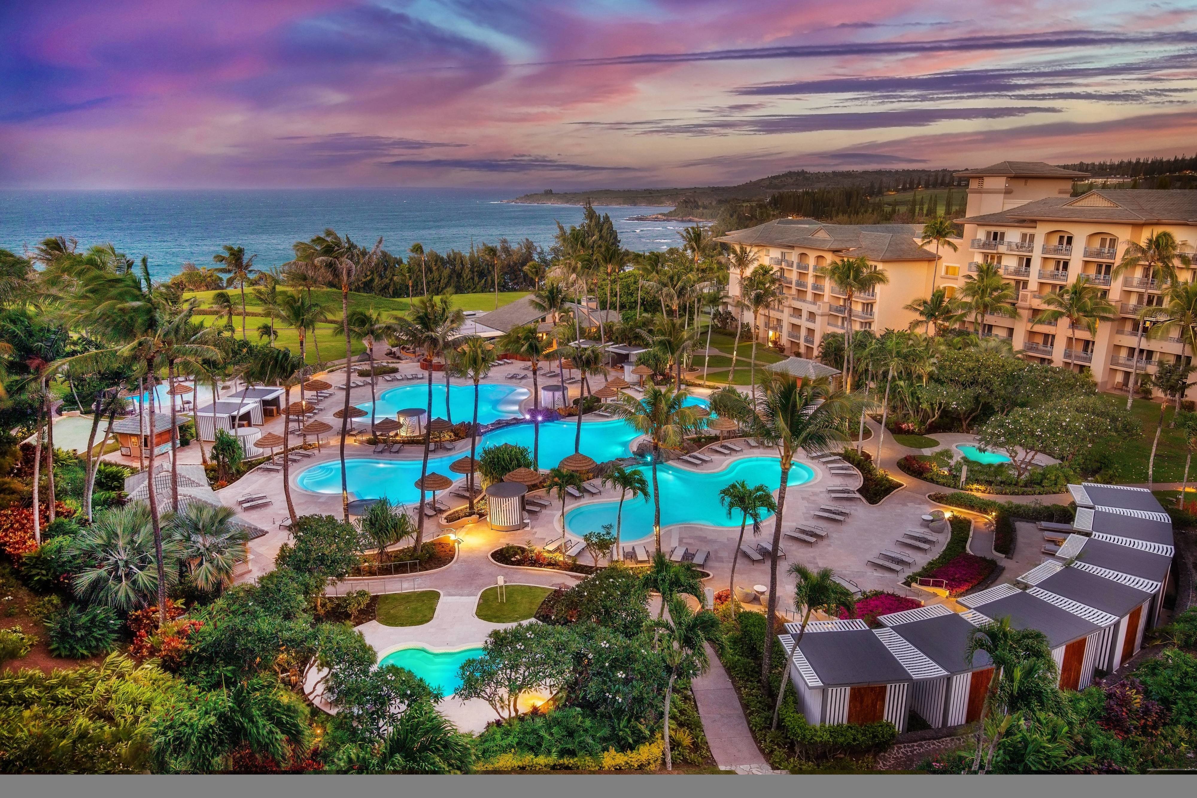 The Ritz-Carlton Maui Kapalua pool complex with multiple swimming pools terraced toward the Pacific Ocean view across to Molokai and Lanai
