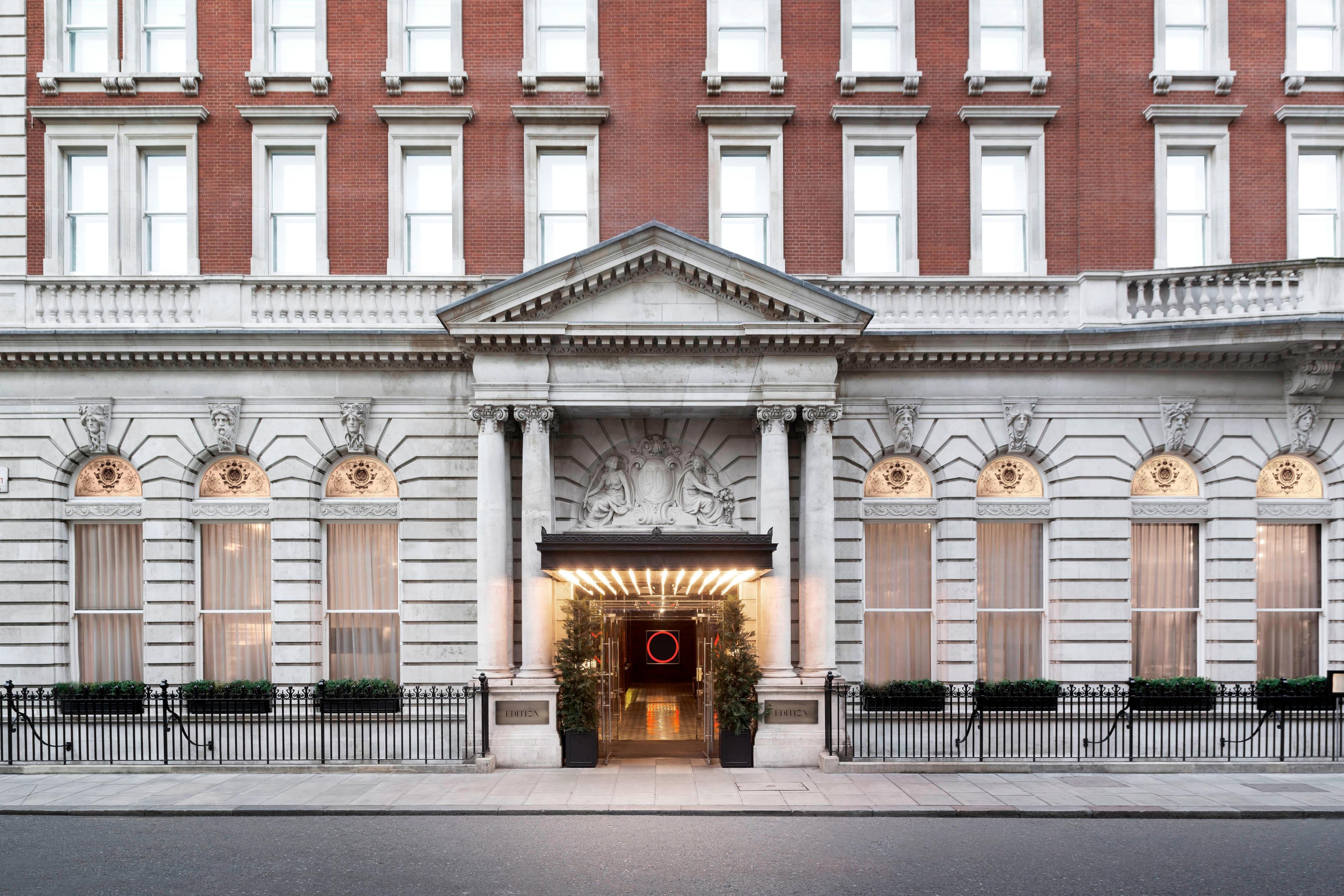 The Edwardian stone and brick facade of The London EDITION on Berners Street with its columned entrance - in the United Kingdom the AA re-inspects rated hotels every year, one of the most frequent official cycles