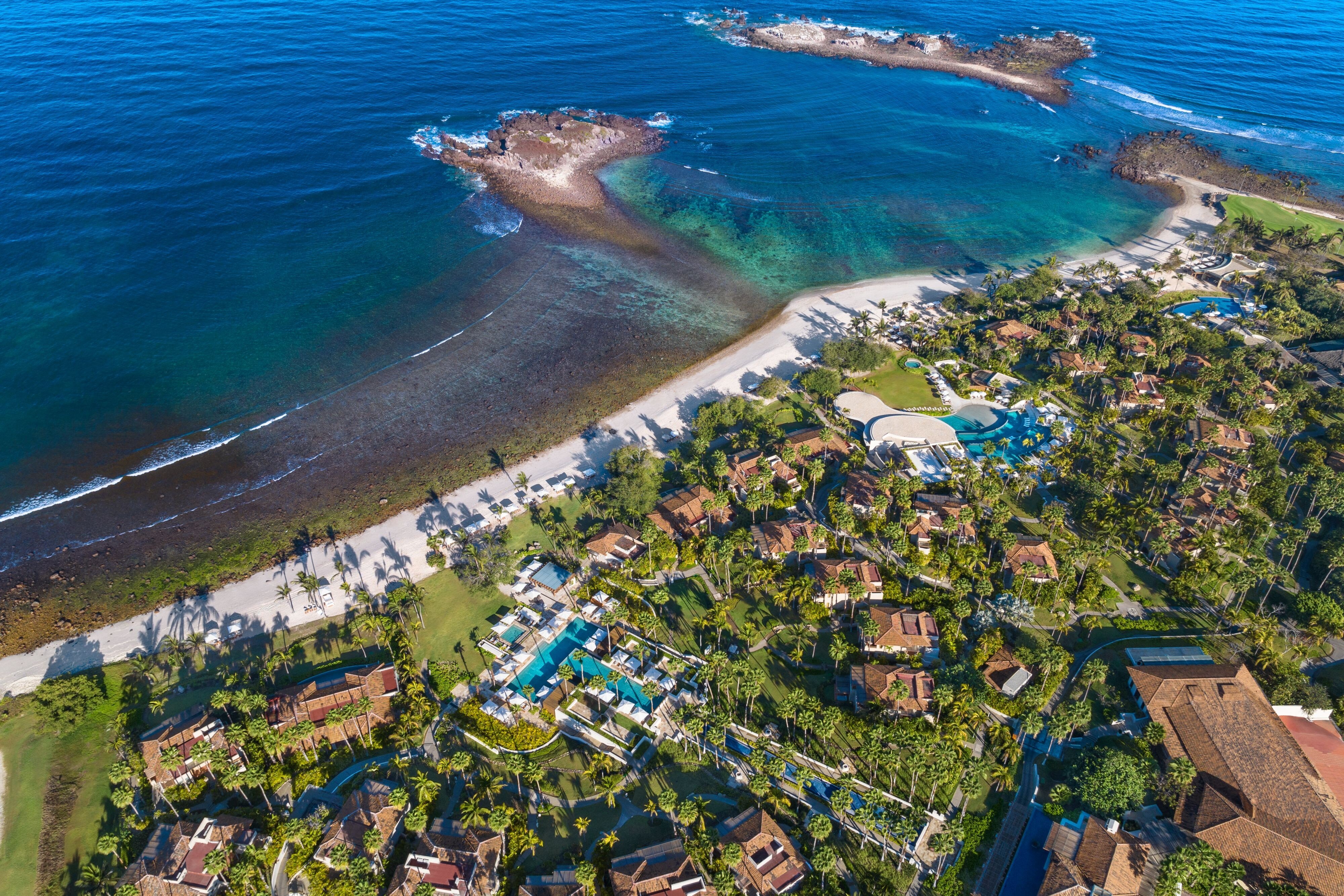 The St. Regis Punta Mita beachfront and multi-pool configuration along the Pacific coast with the dedicated infinity-pool landscape and the Banderas Bay orientation