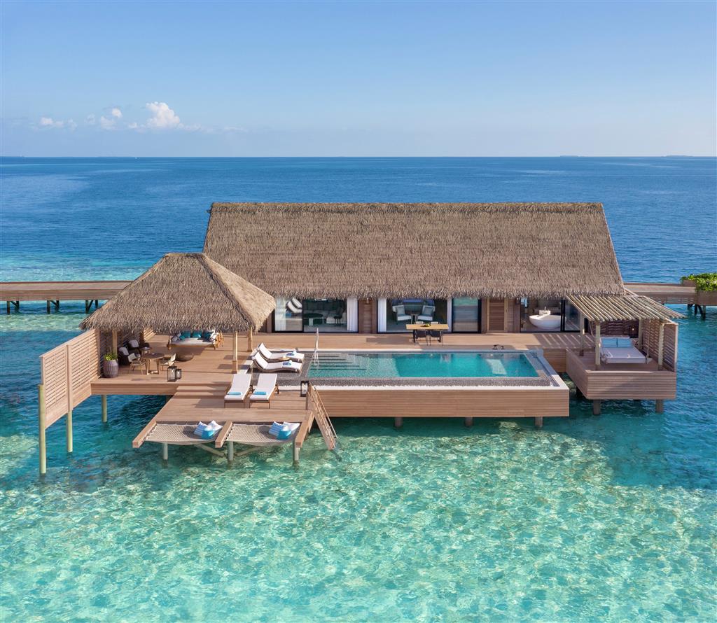 Spa pavilion at Waldorf Astoria Maldives Ithaafushi over the turquoise lagoon waters showing the wellness facility's distinctive architecture