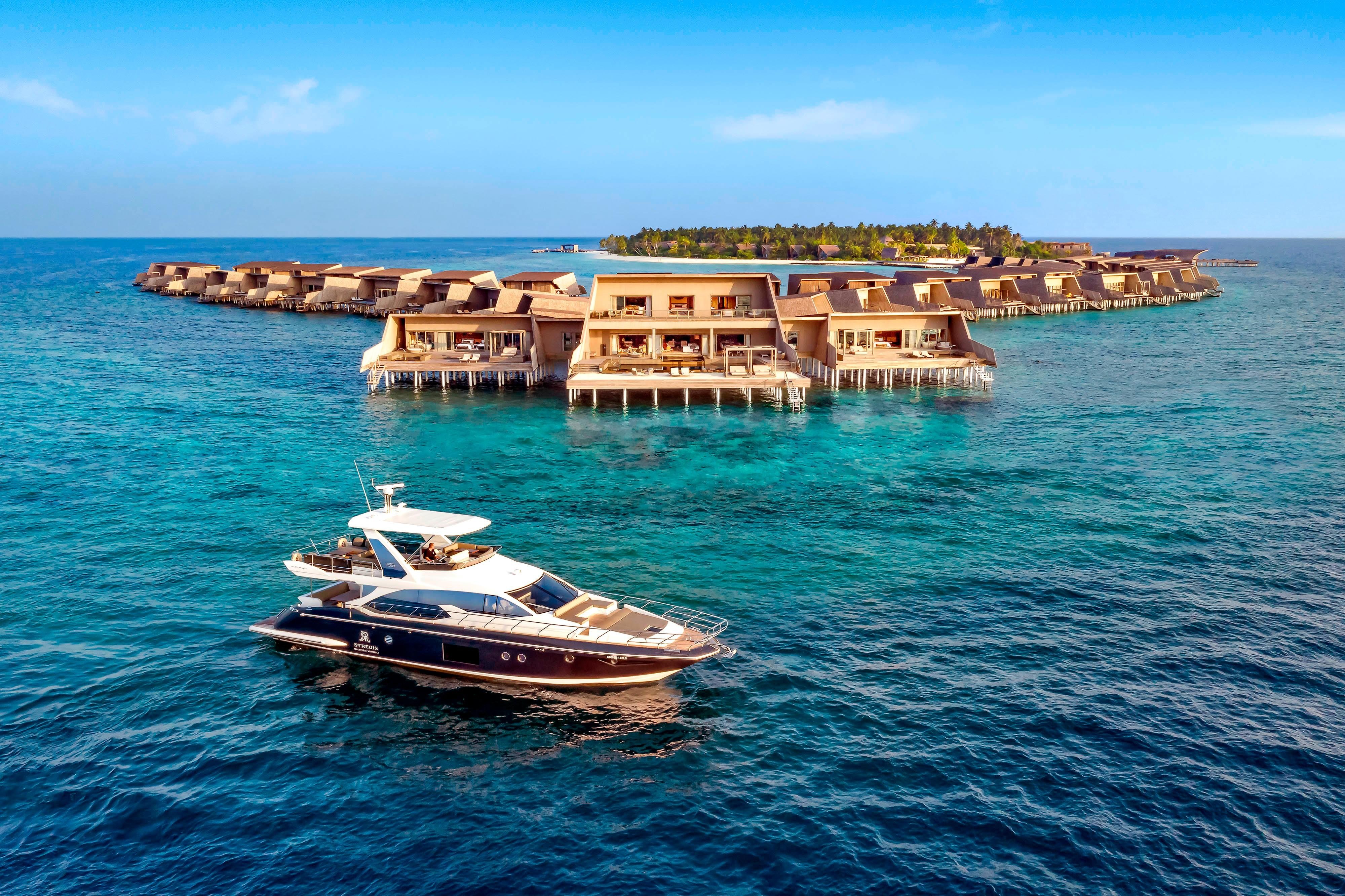 A St. Regis Maldives Vommuli overwater villa with the substantial Indian Ocean orientation and the dedicated private deck-and-pool configuration evocative of the property's substantial overwater-villa identity and the substantial Maldivian luxury vocabulary